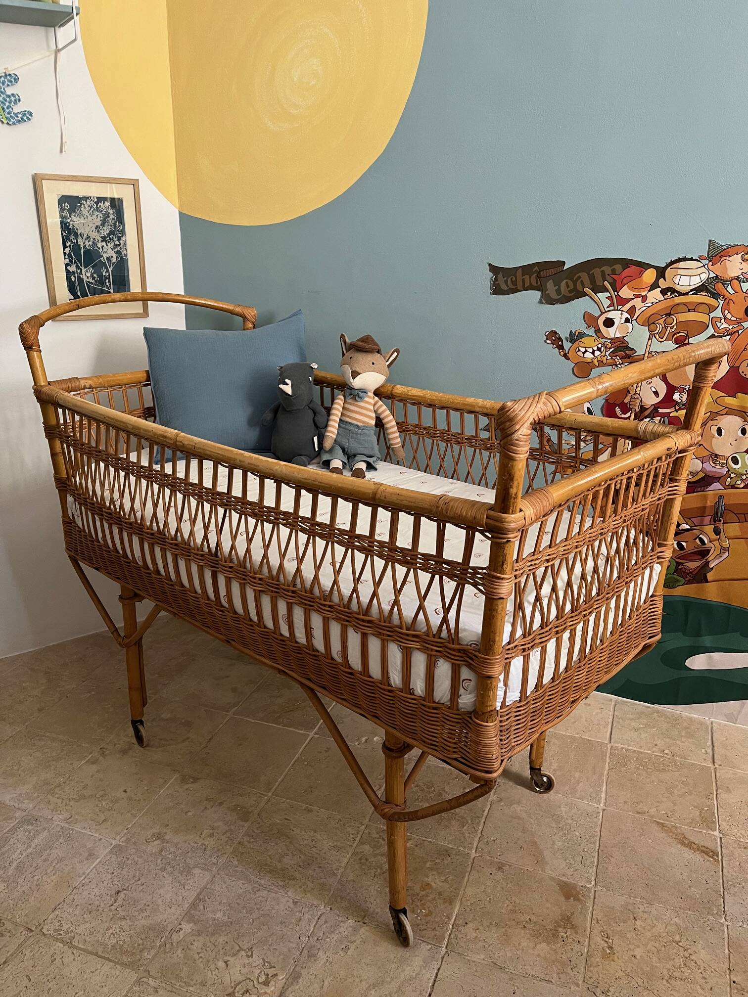 Vintage rattan baby bed with wheels