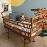 Vintage rattan baby bed with wheels