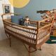 Vintage rattan baby bed with wheels