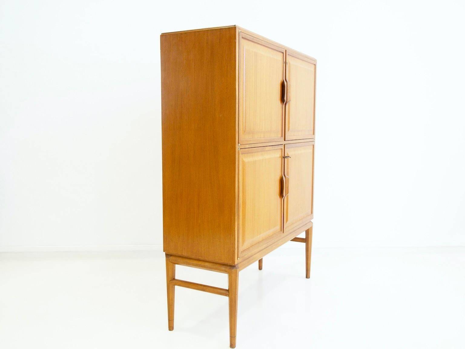 Large Swedish mahogany storage unit with four front doors.
