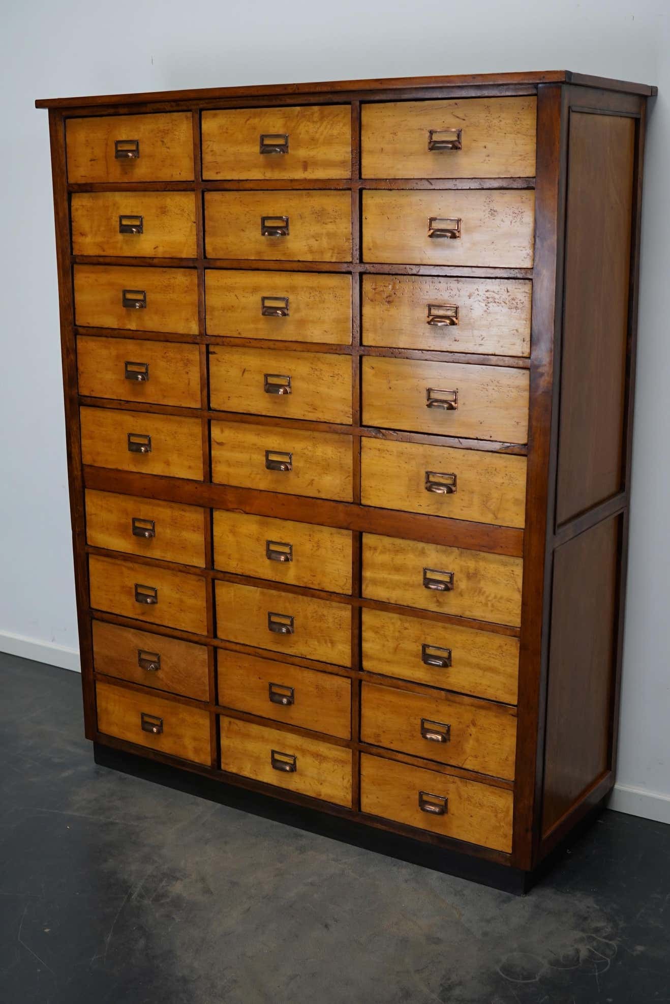 School cabinet bank of vintage Dutch drawers in mid-twentieth century pine