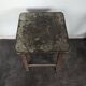 Brown painted wooden workshop stool with a patinated top.
