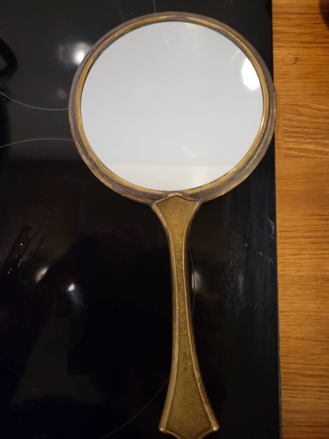 Brass hand mirror with magnifying back