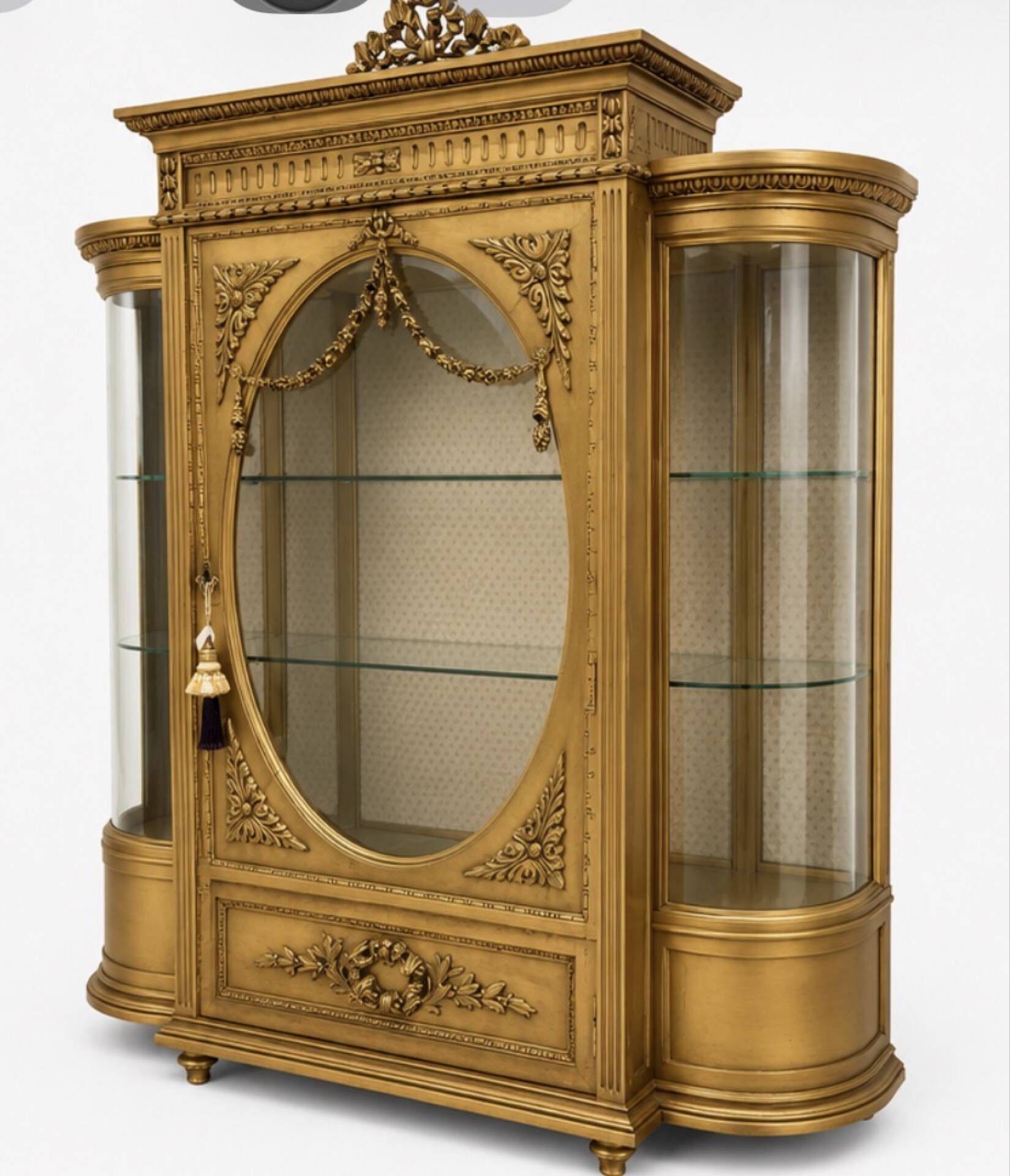 French antique Louis XVI display cabinet in gilded wood with curved glass sides.