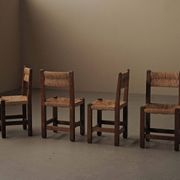 Set of four modernist chairs in oak and straw, France, circa 1960.