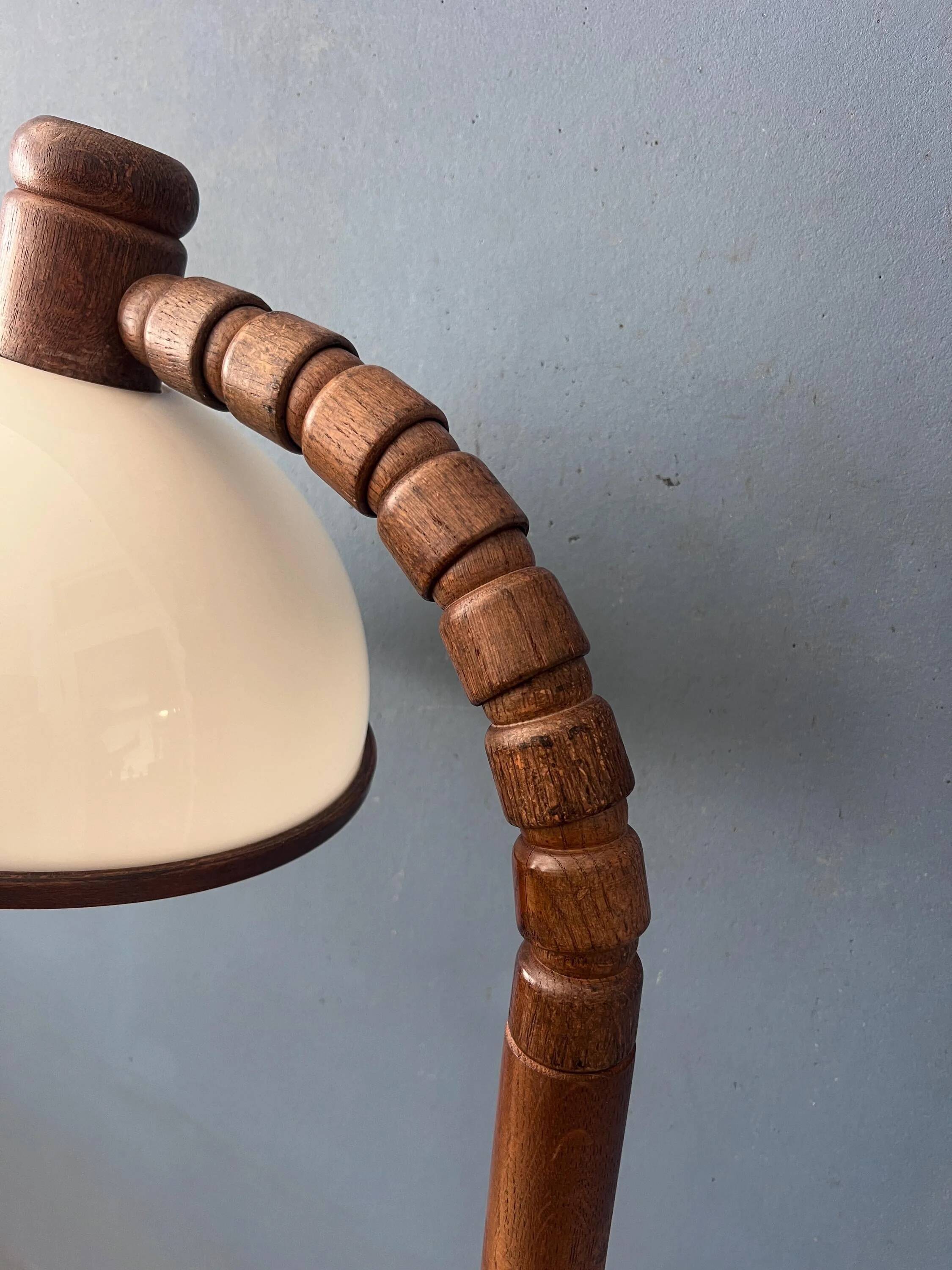 Mid-century floor lamp in brown wood by Steinhauer with an acrylic glass shade.
