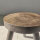 Small brutalistic tripod stool in dark wood tapered feet circular seat