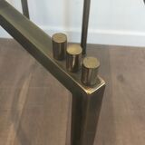 Console en acier brossé et laiton et plateau formé d'une dalle de verre. Travail français. Vers 1970