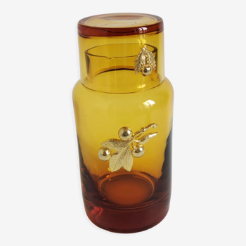 Vintage decorative bottle in brown glass decorated with golden plants