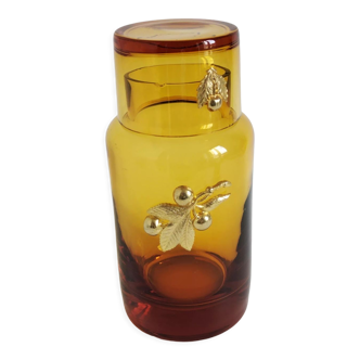 Vintage decorative bottle in brown glass decorated with golden plants