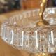 Footed catch-all / ashtray with cherub (glass and gilded metal)