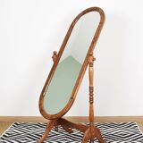 Large psychic mirror on legs with pivoting oval frame.