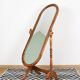 Large psychic mirror on legs with pivoting oval frame.