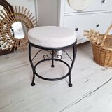 Black iron stool/pouf with its boucle fabric cushion.