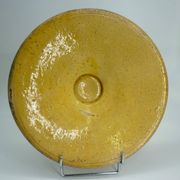 Old omelette turner, glazed yellow terracotta, south of France.
