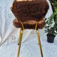 Vintage shaggy chair in faux fur with golden metal legs.
