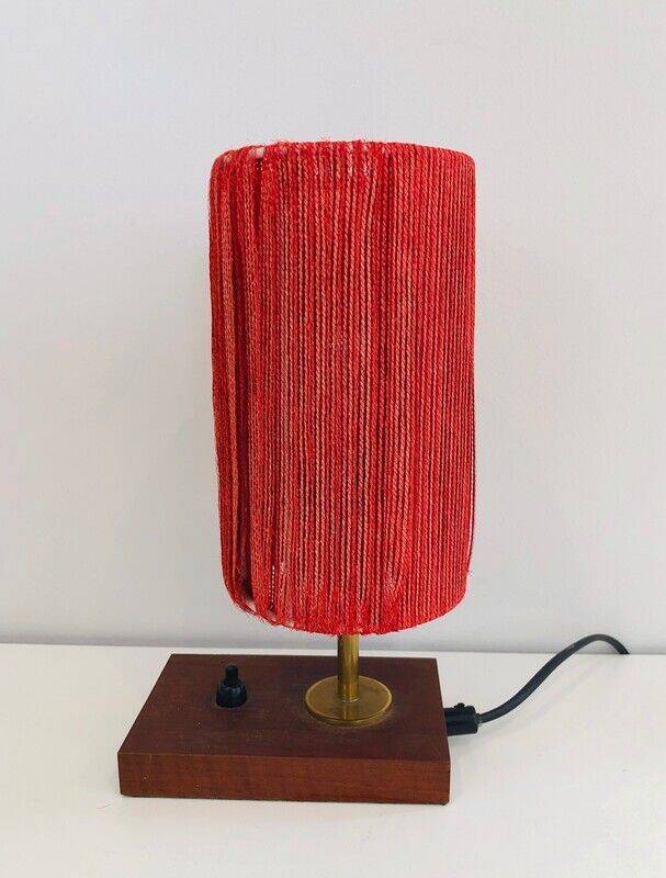 Small lamp made of wood, brass, and wool.
