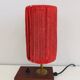 Small lamp made of wood, brass, and wool.