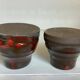 Pair of red vases in the shape of an elephant's foot