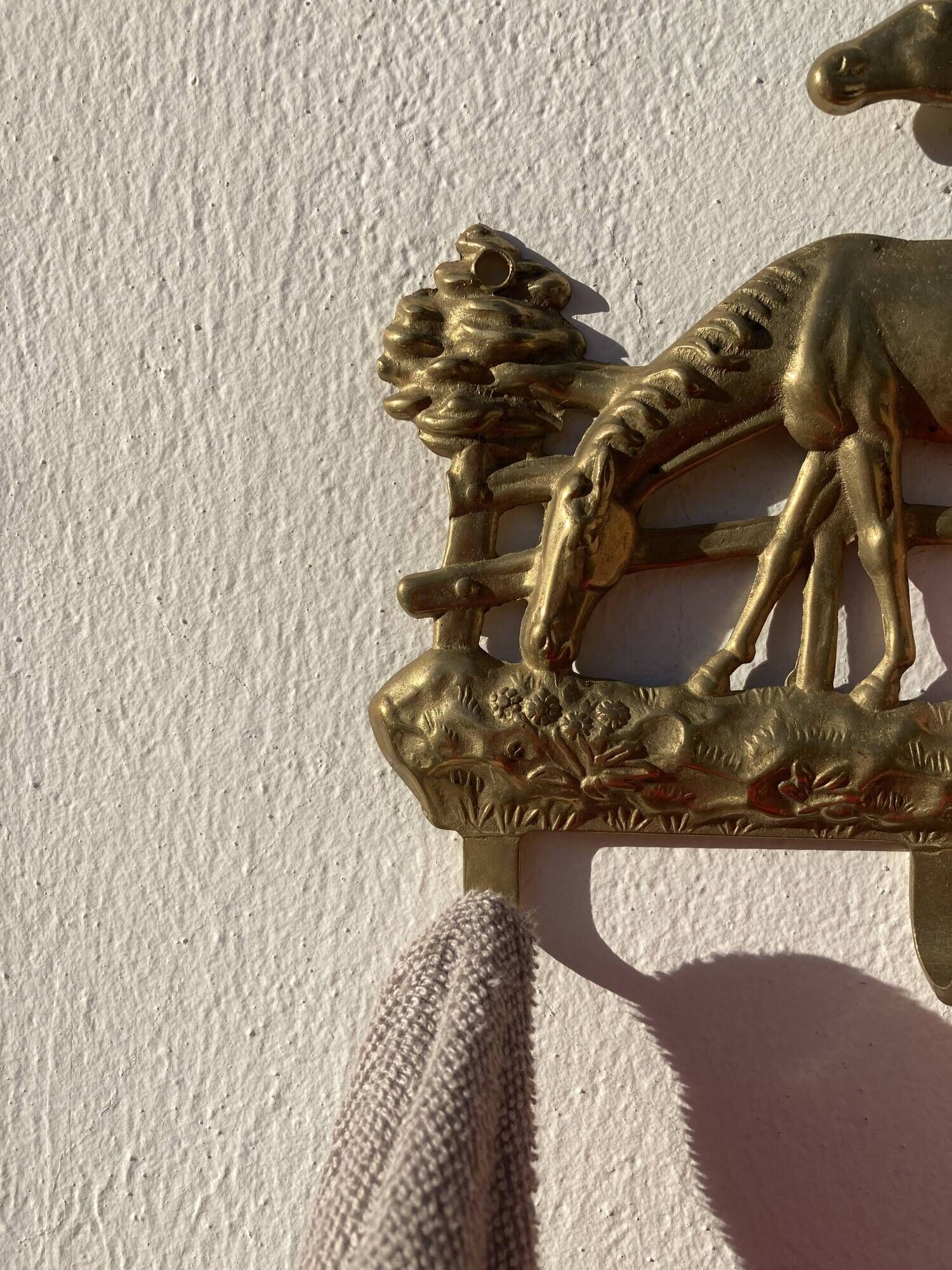 Hook for keys or tea towels in gilded brass with carved horse decoration