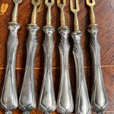Set of knives and forks for fruits.