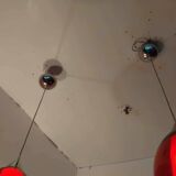 Pair of conical pendant lights in red tinted glass