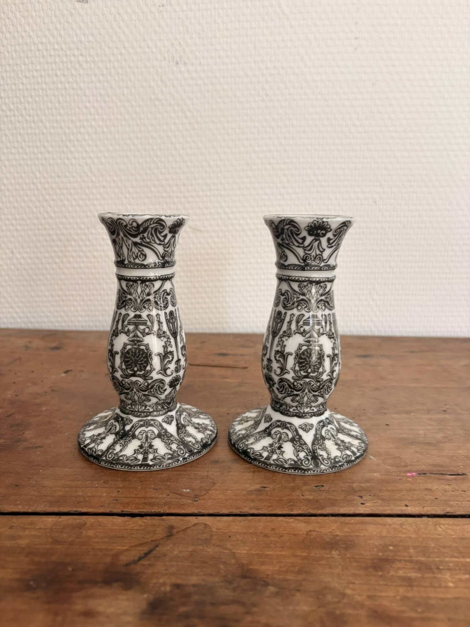 Pair of White and Black Porcelain Candle Holders with Berain Scroll Decoration, Baluster Style