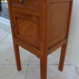 Antique bedside table with its marble top and white earthenware interior