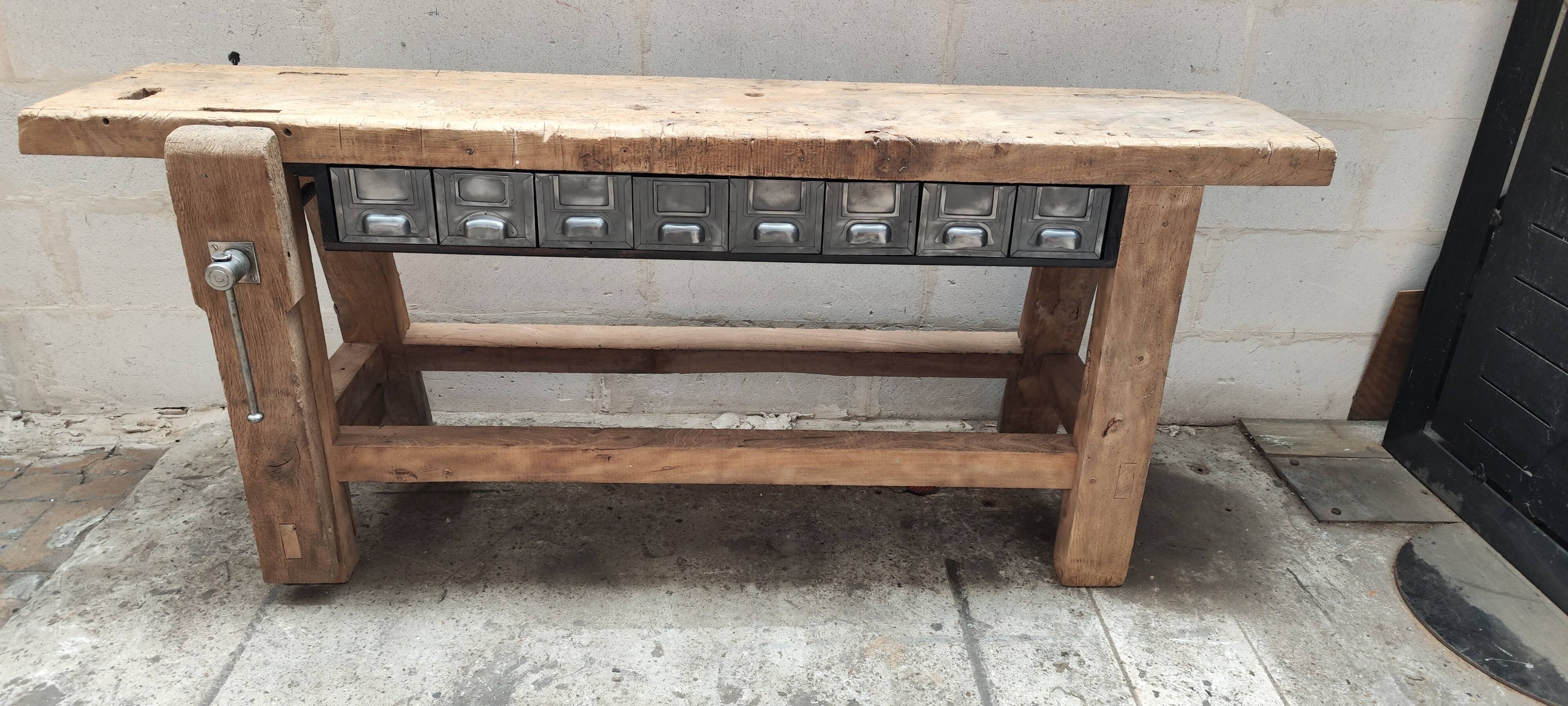 Old carpenter's workbench with eight metal drawers, industrial console