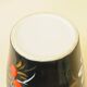 Vintage black ceramic vase with painted floral decoration – stylised colourful flowers.