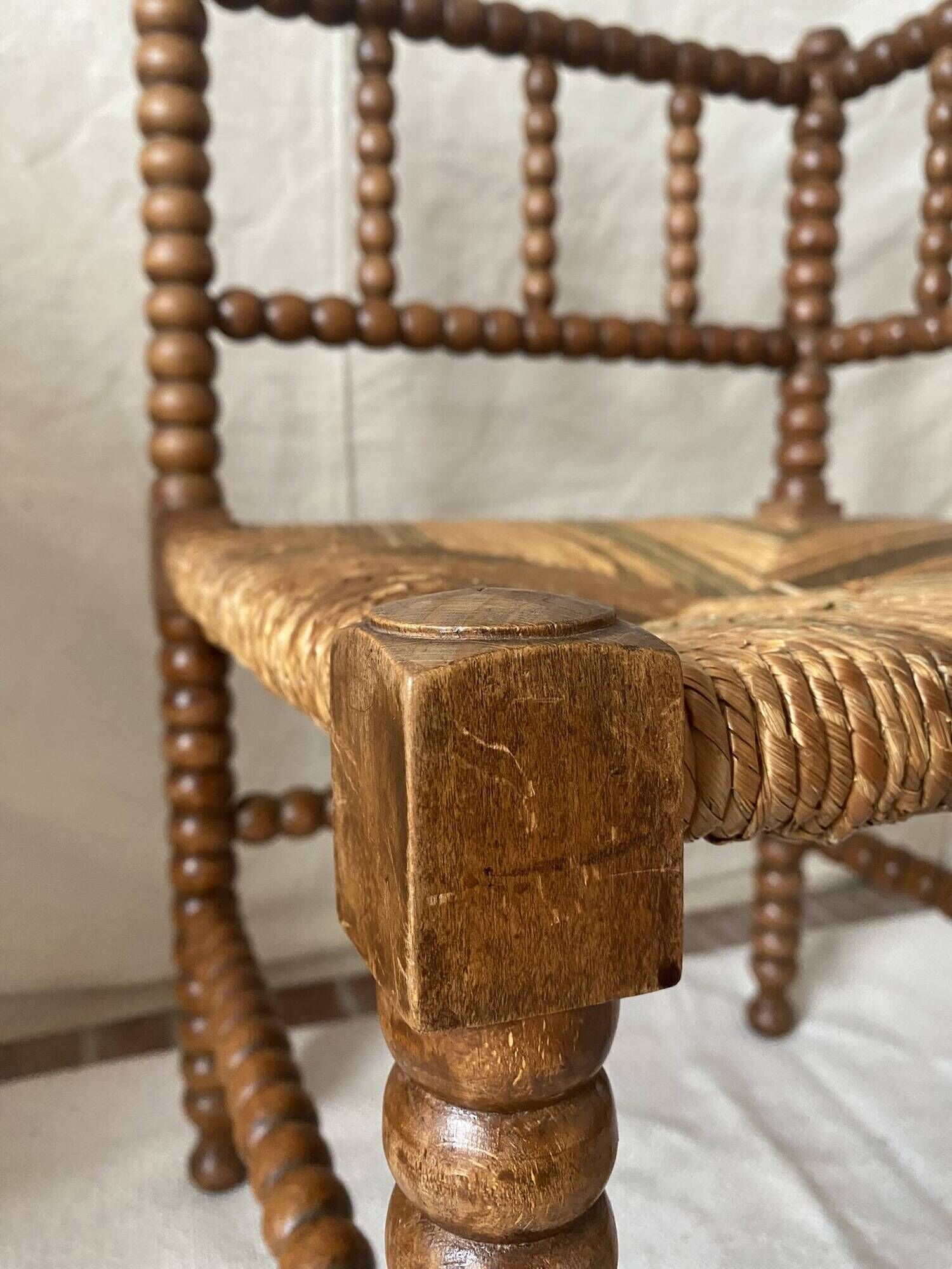 Corner chair in straw and turned wood, fireside chair.
