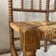 Corner chair in straw and turned wood, fireside chair.