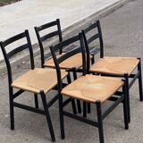 4 black Scandinavian chairs with solid wood and cord.