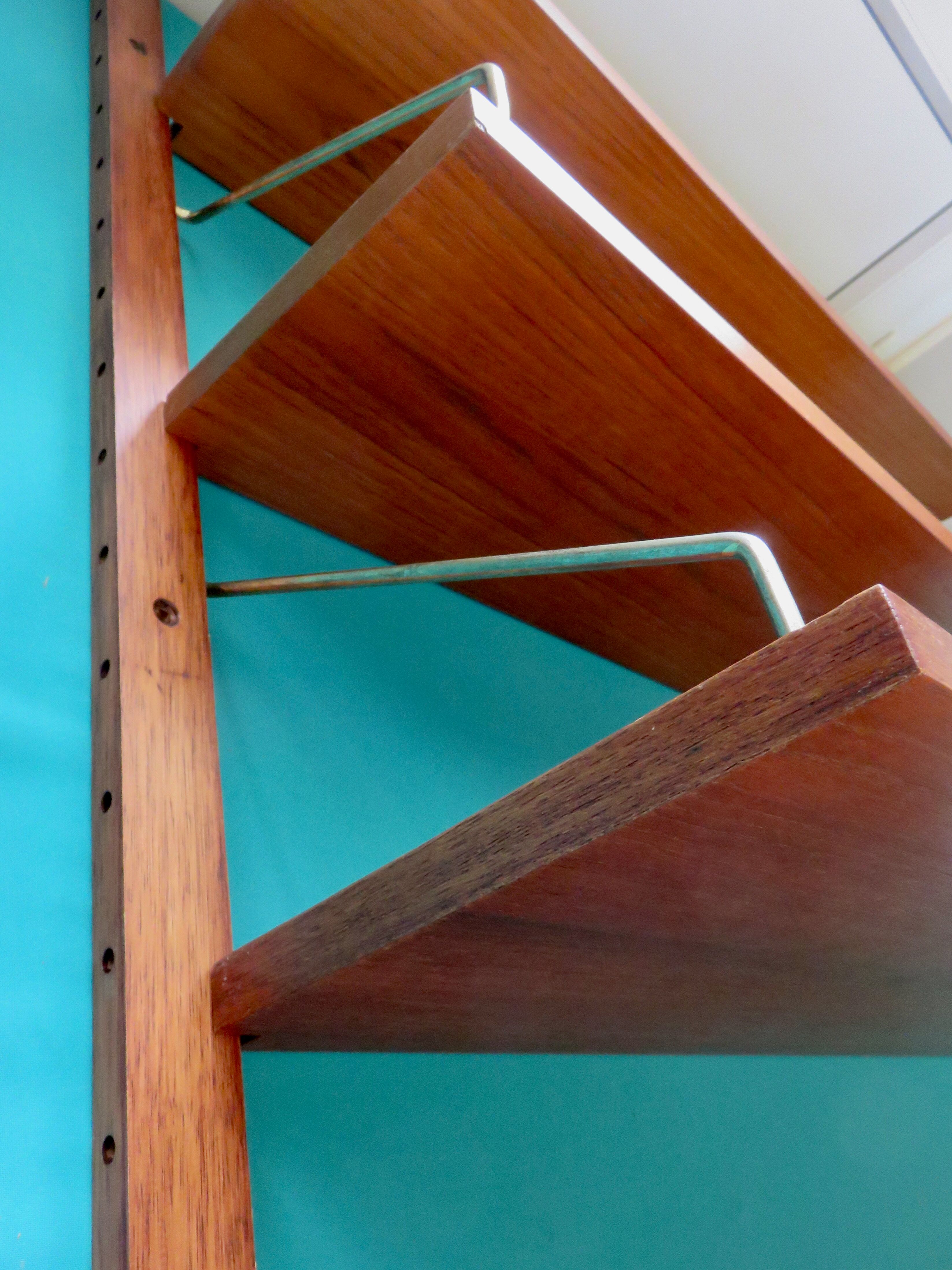 Wall shelving system and teak writing box. of Poul Cadovius. Denmark 1960