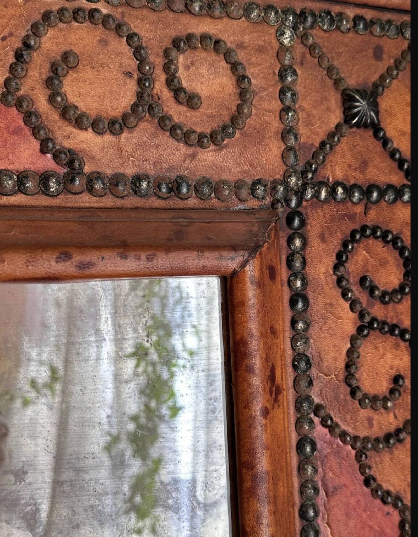 Antique mirror designed by "Pierre Lottier". Leather and nails. France 1