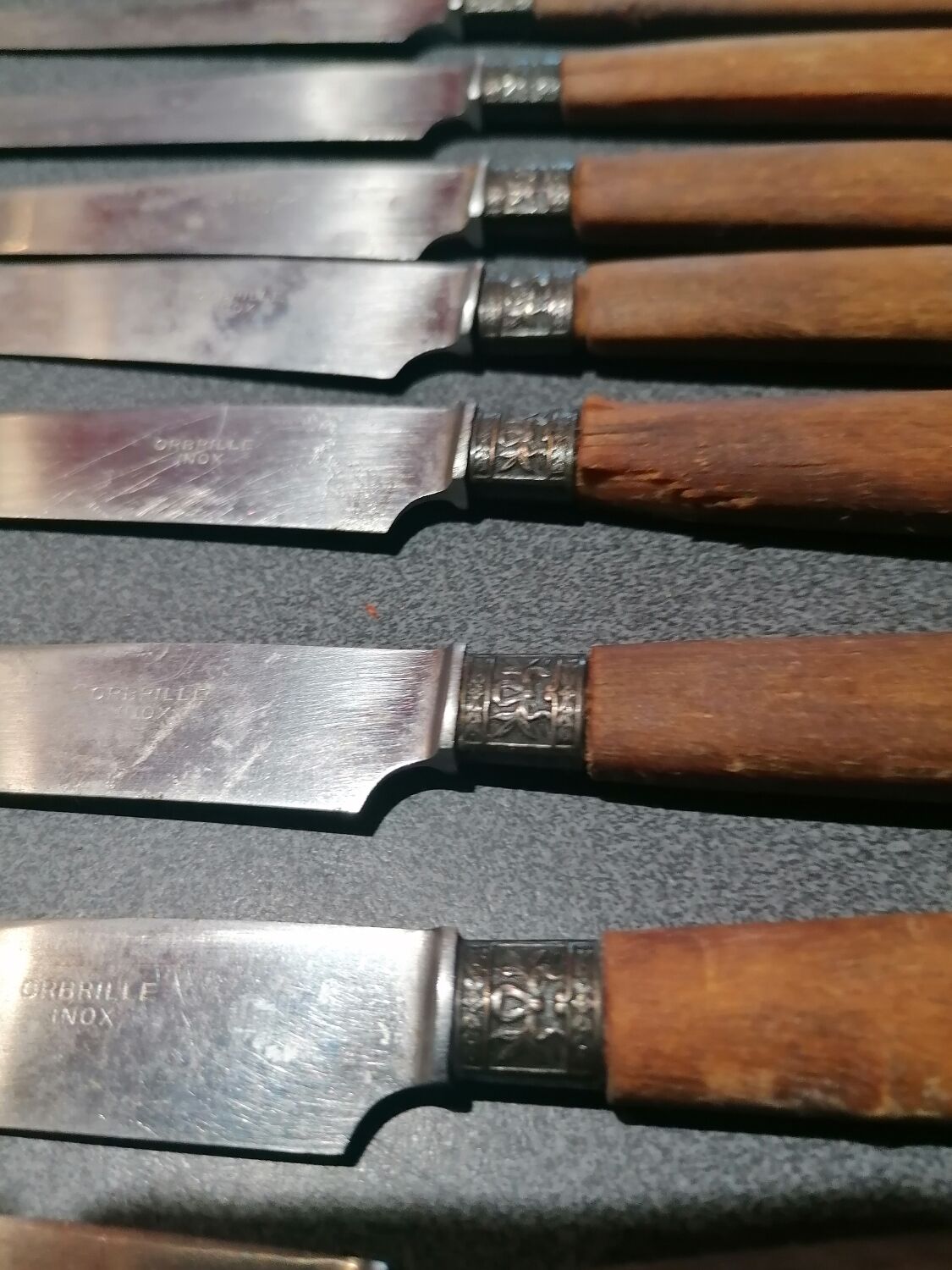 Old table knives and dessert knives, wooden handles, stainless steel blades
