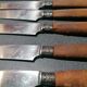 Old table knives and dessert knives, wooden handles, stainless steel blades