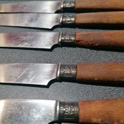 Old table knives and dessert knives, wooden handles, stainless steel blades