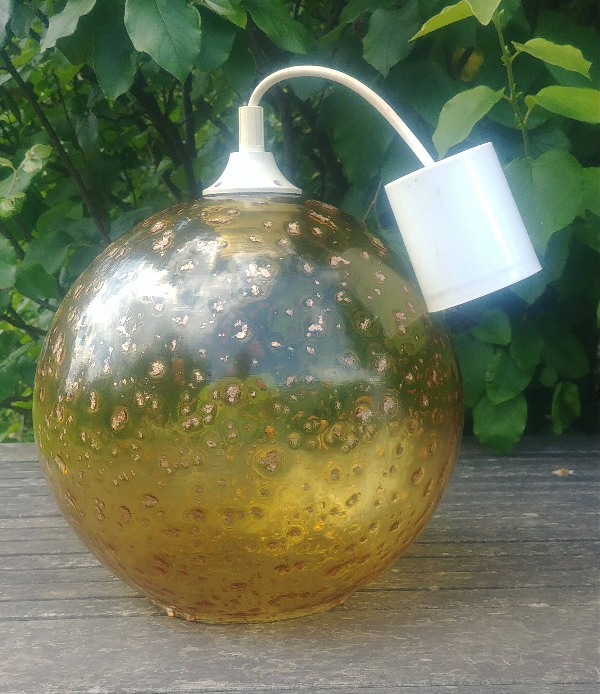 A vintage 70s blown glass pendant light with gold glitter in a globe shape
