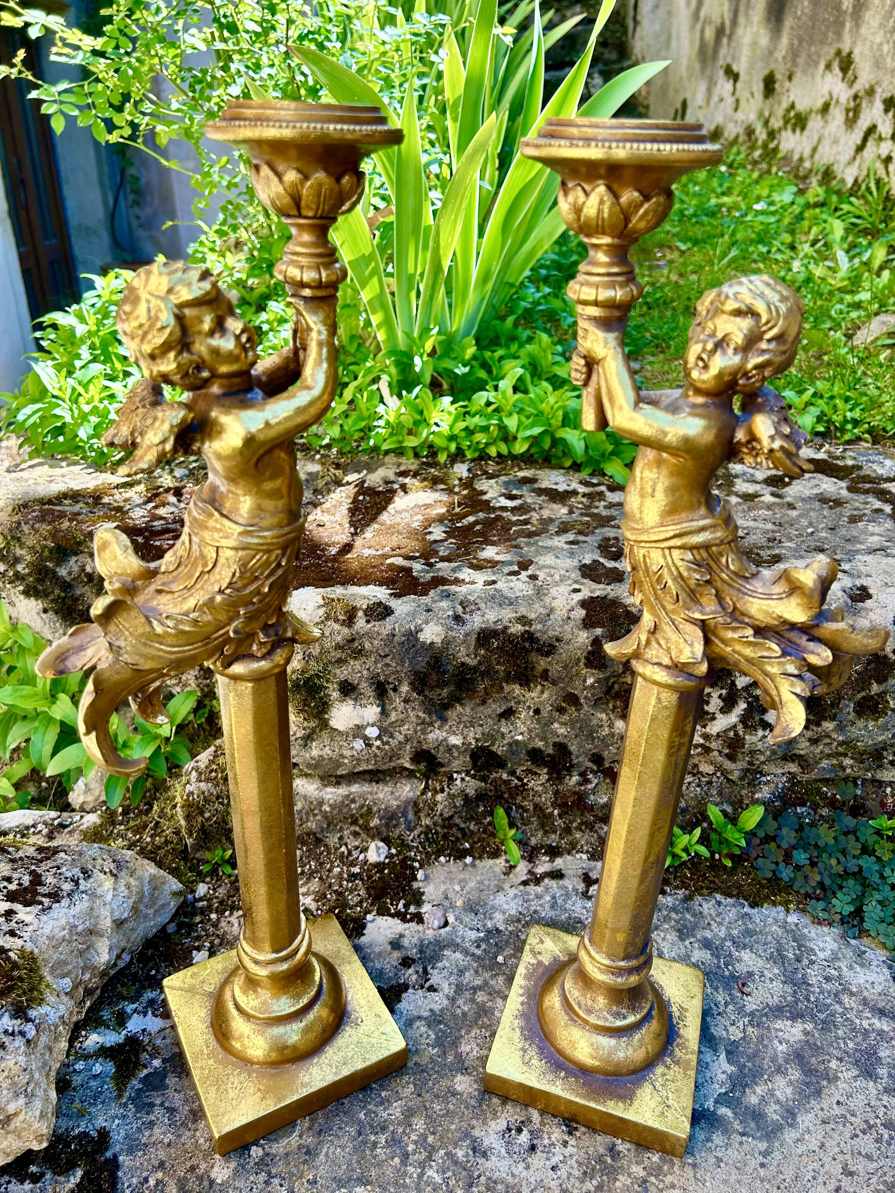 Pair of large candlesticks with cherubs