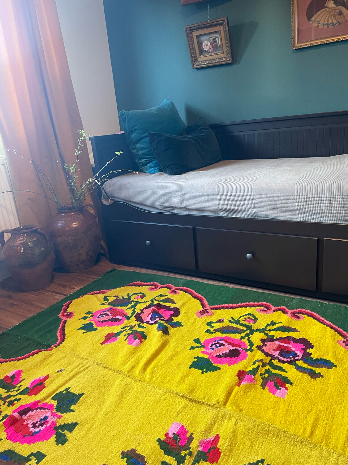 Vintage wool rug with pink flowers on green and yellow background made by hand in Transylvania