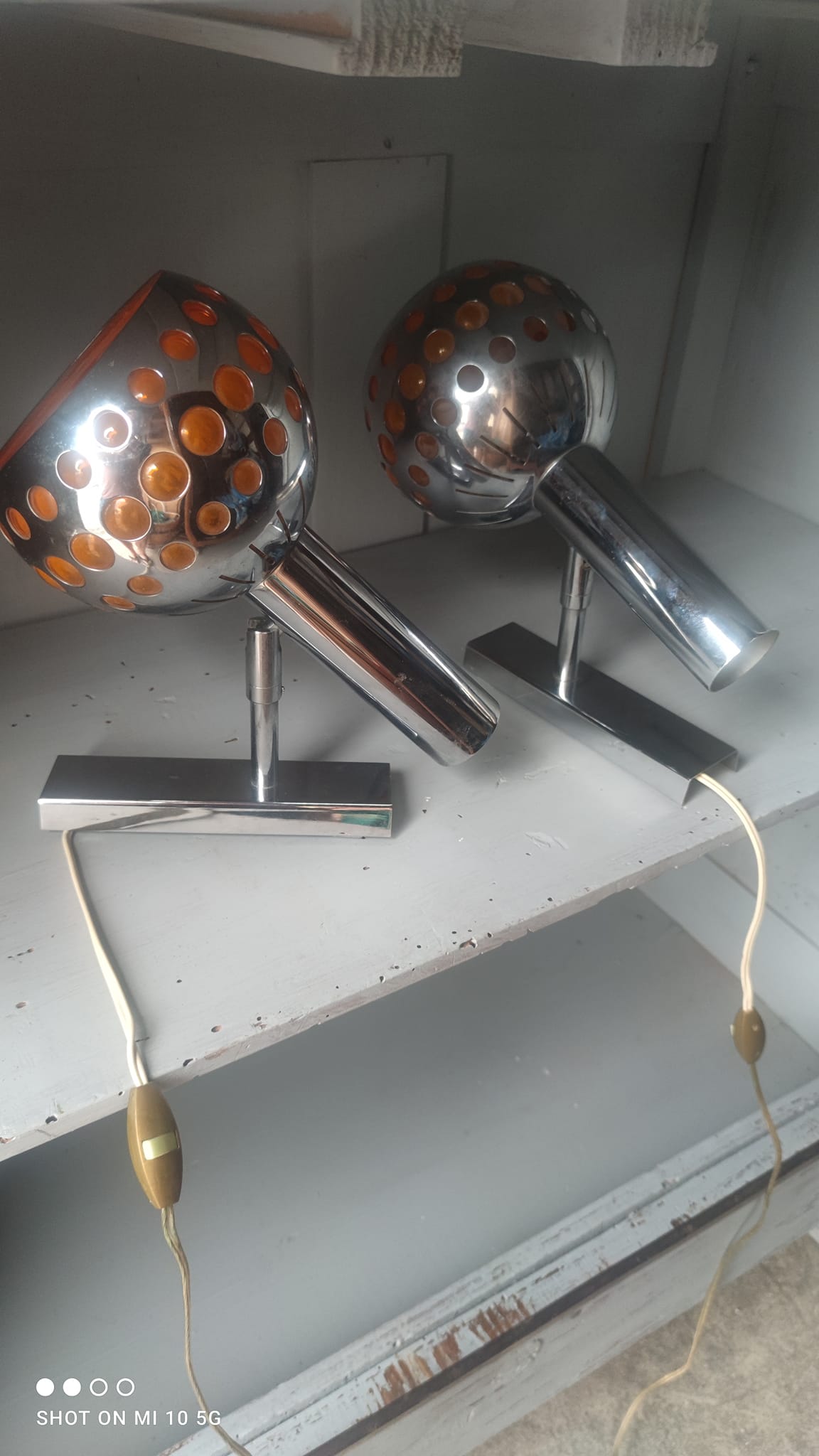 Pair of chrome-plated metal wall lights with adjustable ball joints, circa 1970