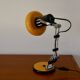 Articulated orange Aluminor desk lamp industrial design 70s