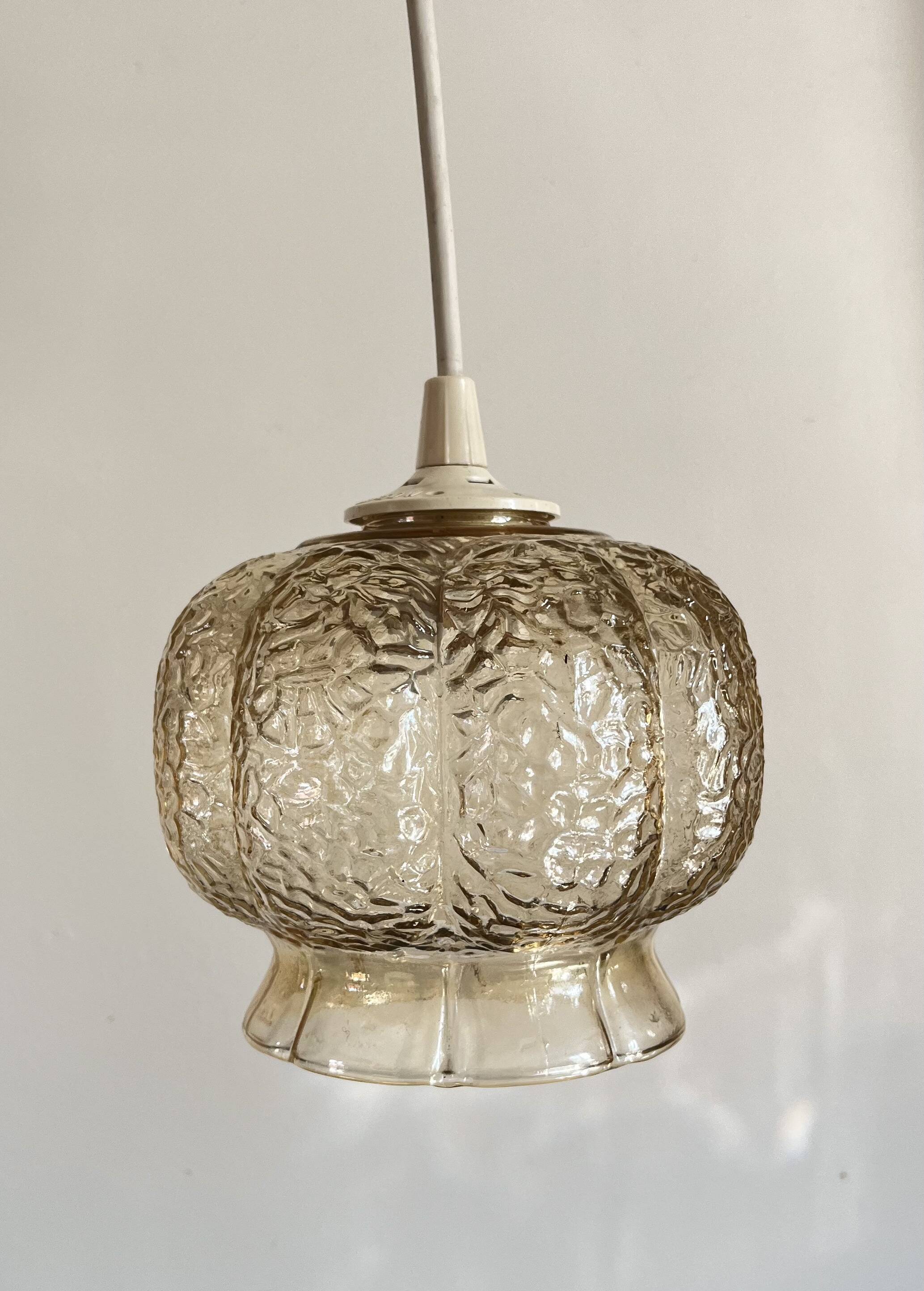 Small glass ball pendant light with amber plant effect