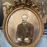 Old ancestor portrait in a gilded oval frame with Louis XVI style knot decoration