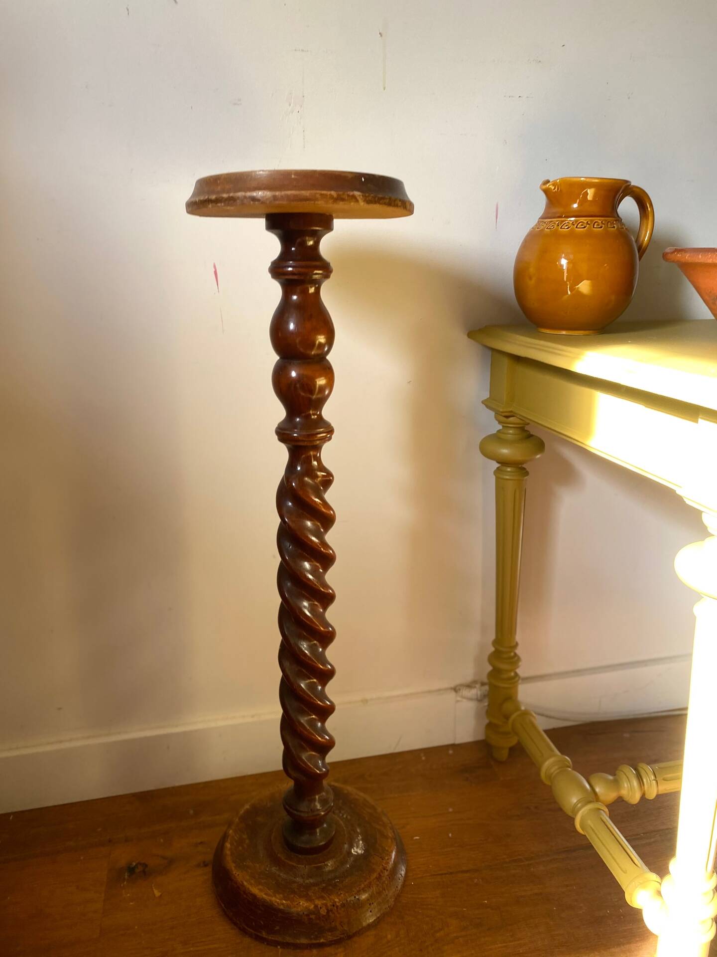 Antique pedestal table with a twisted column.
