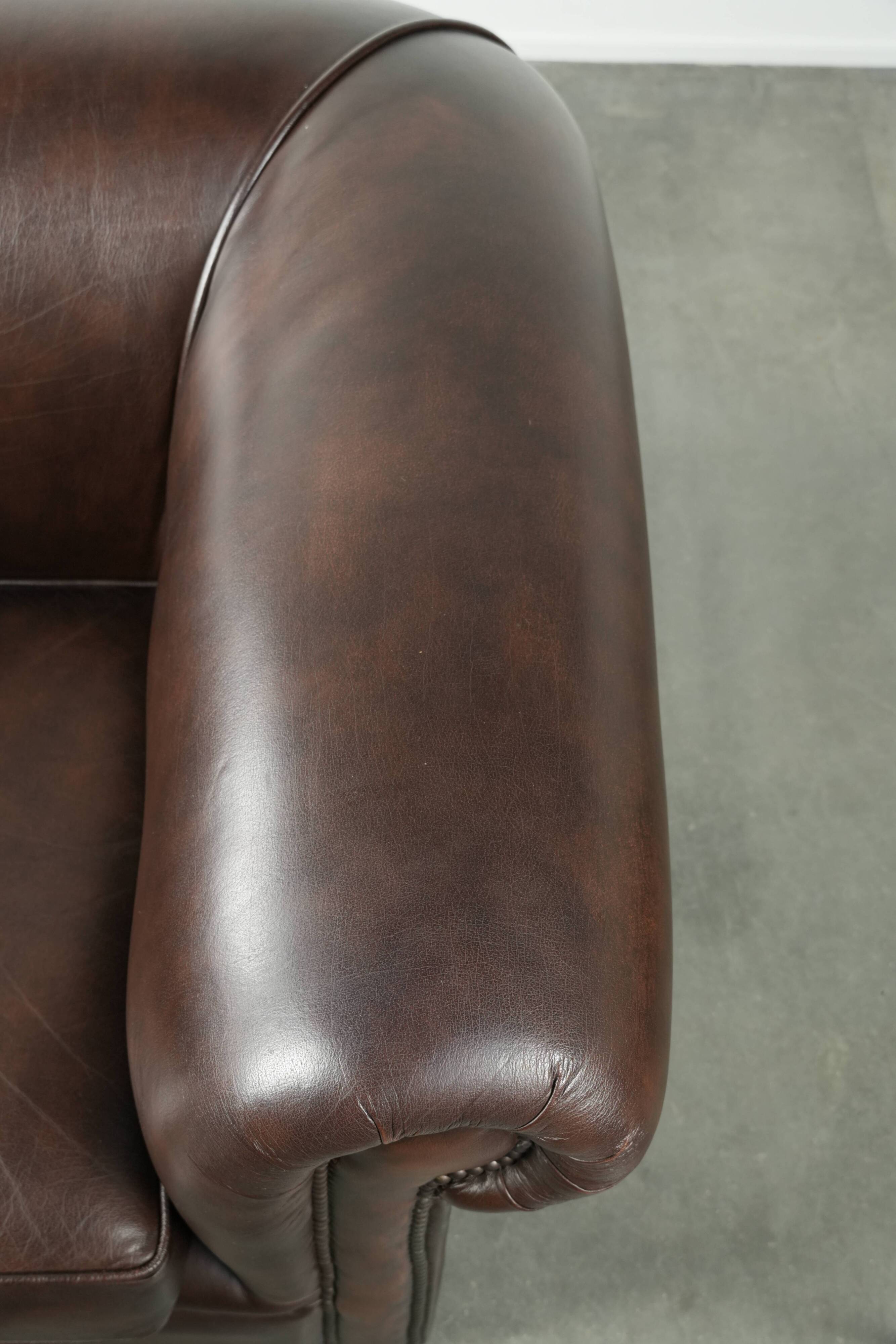 Set of a smooth chesterfield sofa and armchair with a timeless English look
