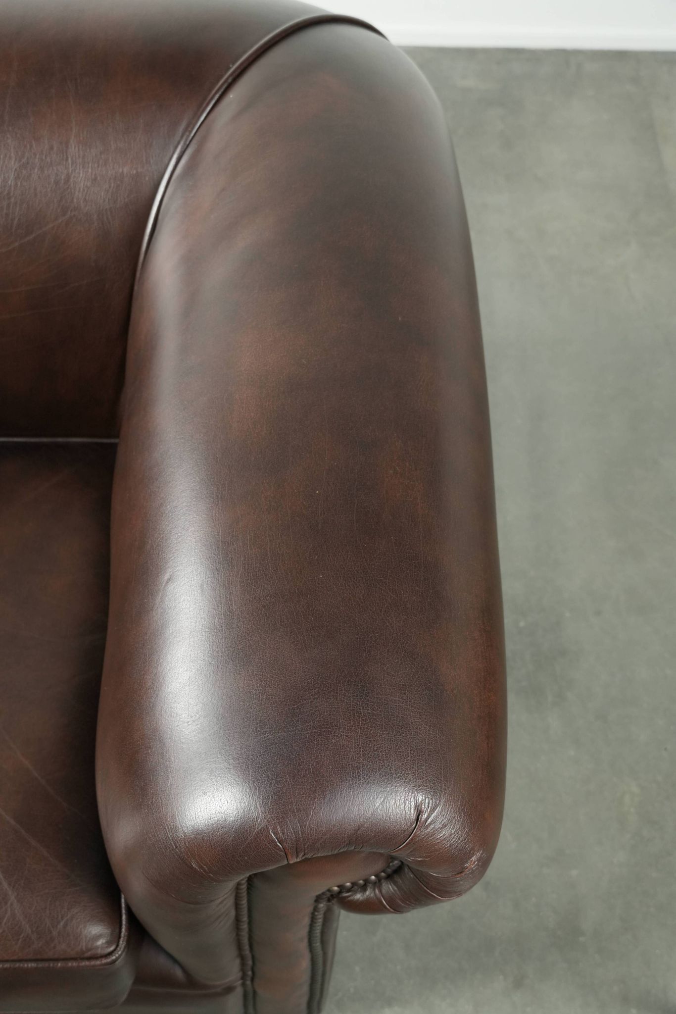 Set of a smooth chesterfield sofa and armchair with a timeless English look