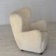 Fauteuil danois des années 1960, en véritable peau de mouton "Canberra", retapissé.