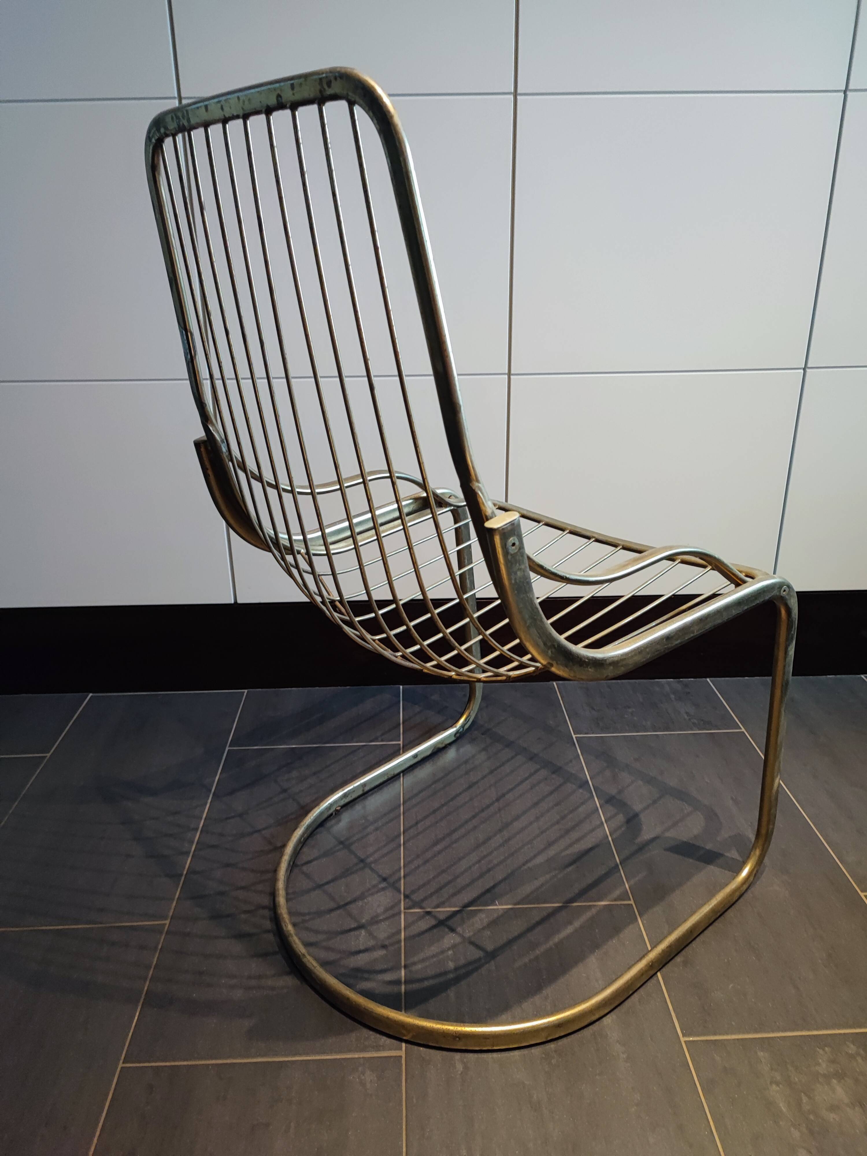 Tubular metal chair covered with gilding